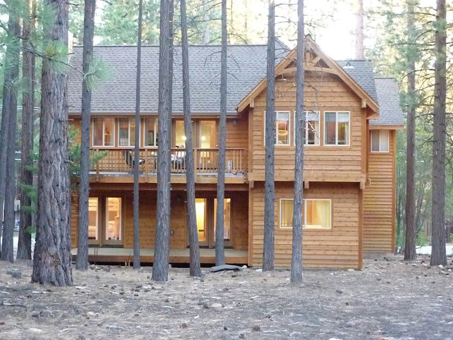 Rear of home with view of upper and lower decks