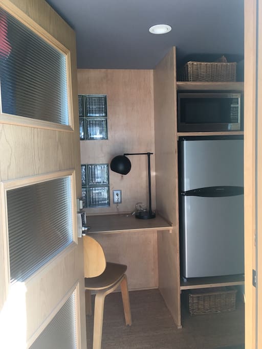 Your entry, with built in desk, plenty of hooks behind the door, fridge/freezer, microwave and extra storage.