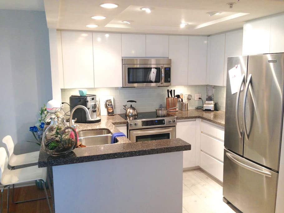 Vitamix style blender and top of the line coffee maker in this well laid out kitchen
