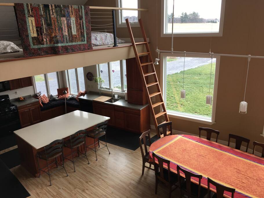 Carpeted loft above the kitchen with room for extra sleepers. There are 7 leaves for the dining table. We've seated 18 at it. Large windows with great views south, east, and west.
