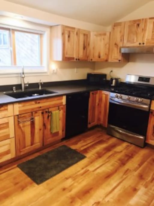Kitchen has hickory cabinets, quartzite counter top, instant hot water, gas stove, dishwasher, etc.