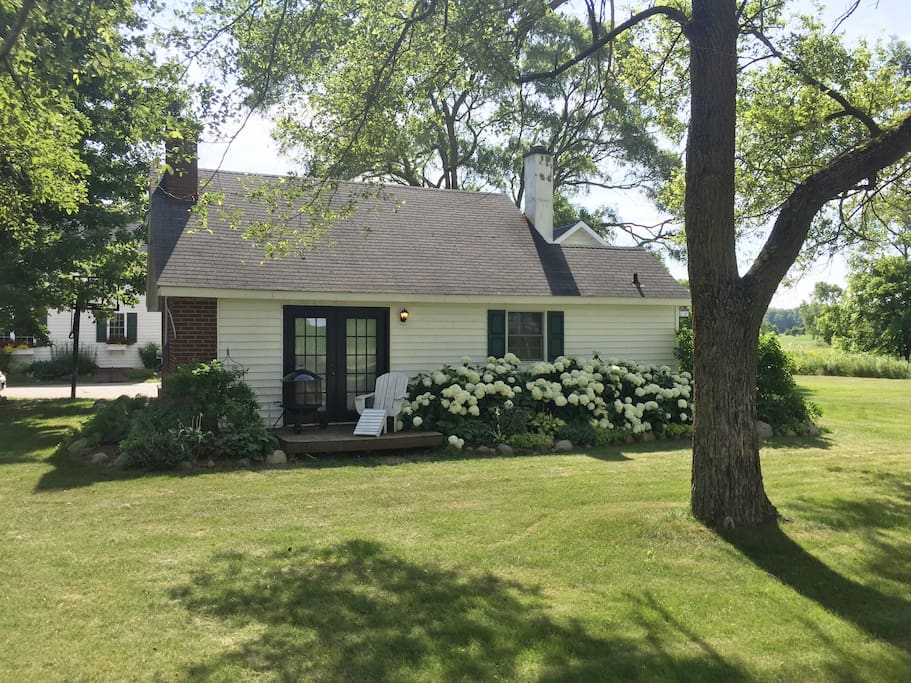 You can see the main house behind the cottage. It shares the driveway. However, the side yard is completely reserved for the use of the cottage guests. They are about 50 feet apart.