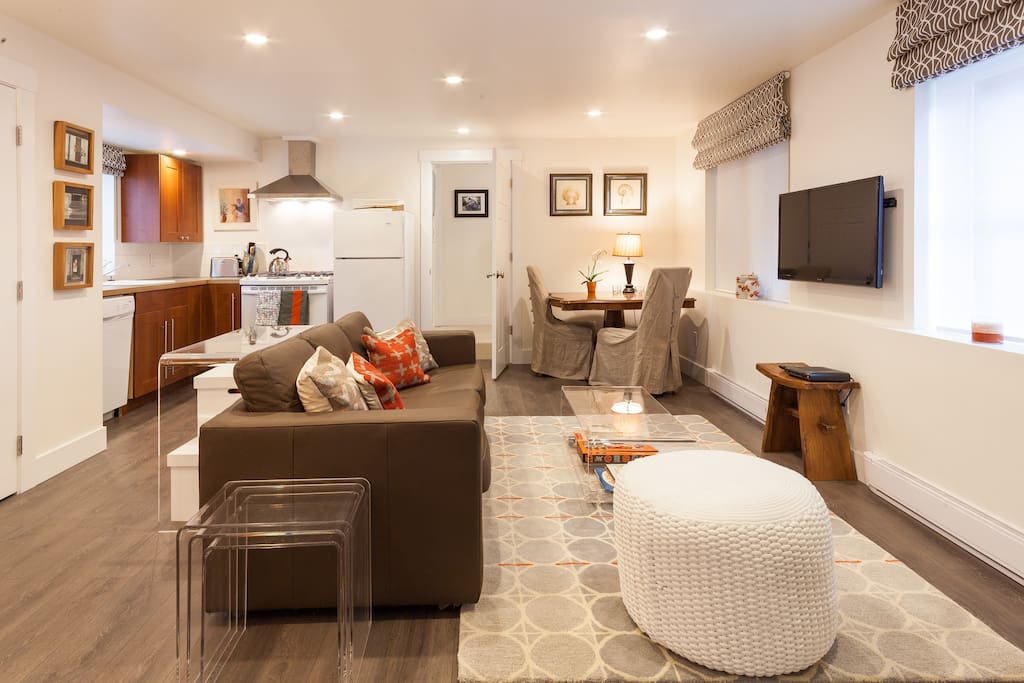 Neutral tones with orange accents make this both a very comfortable, functional and bright space