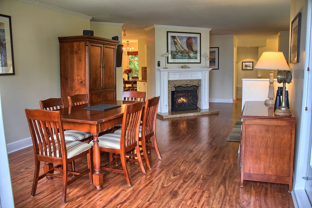 The dining table can seat 6 people and there is a cozy fireplace