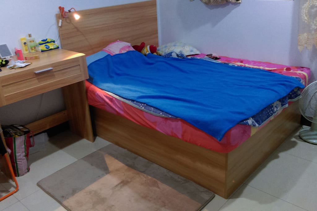 雙人床含毯子及枕頭。
A double bed with blankets and a pair of pillows.