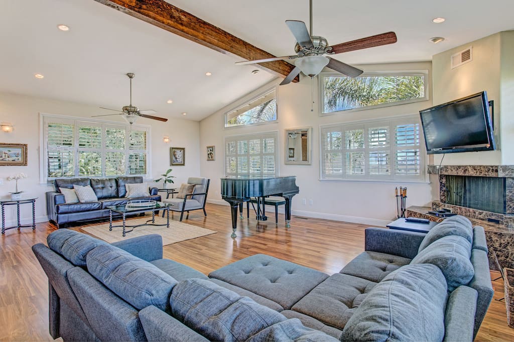 Open and bright living room with a grand piano