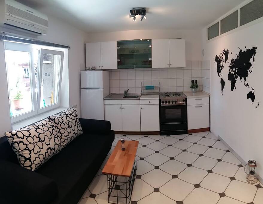 Kitchen and living room with foldable sofa bed