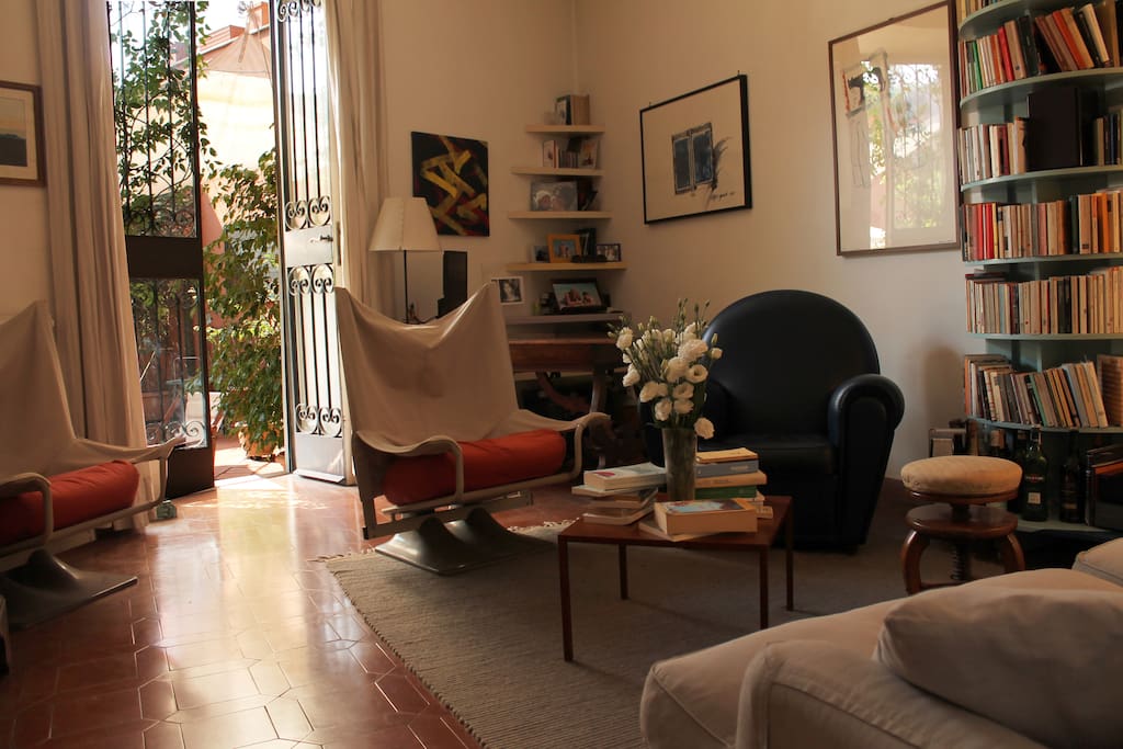 The living room is airy and spacious, opening onto the terrace.