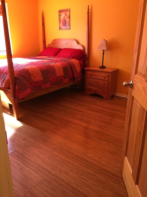Cozy queen size bed with room for a twin roll-a-way.