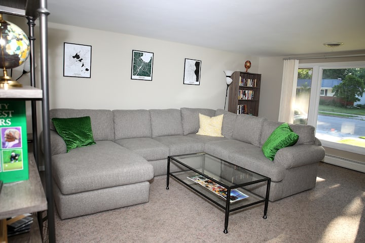 Spacious living room with huge, comfy couch. The perfect place to relax before (or after) game day!