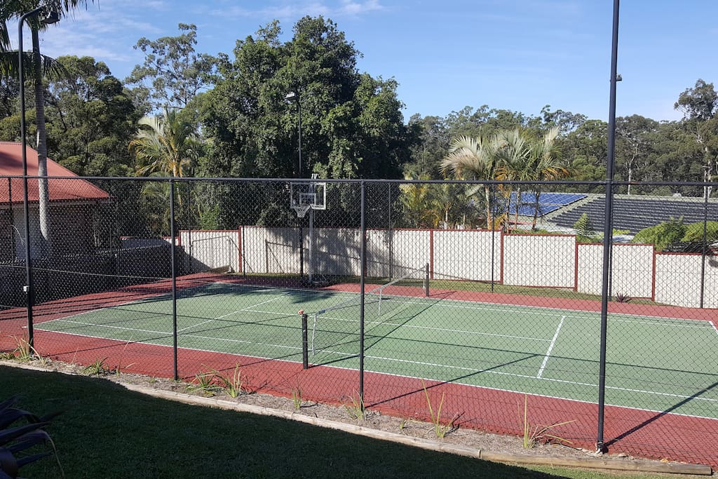 Half tennis court, balls and rackets provided. Basketball hoop.