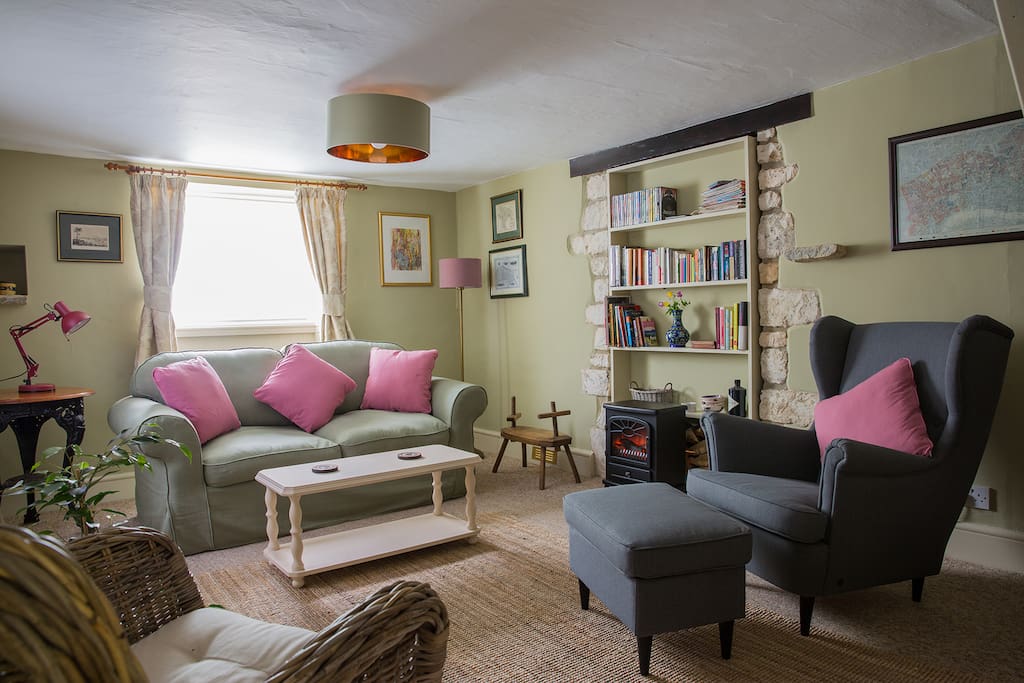 Cosy sitting room including a sofa bed with linen provided.