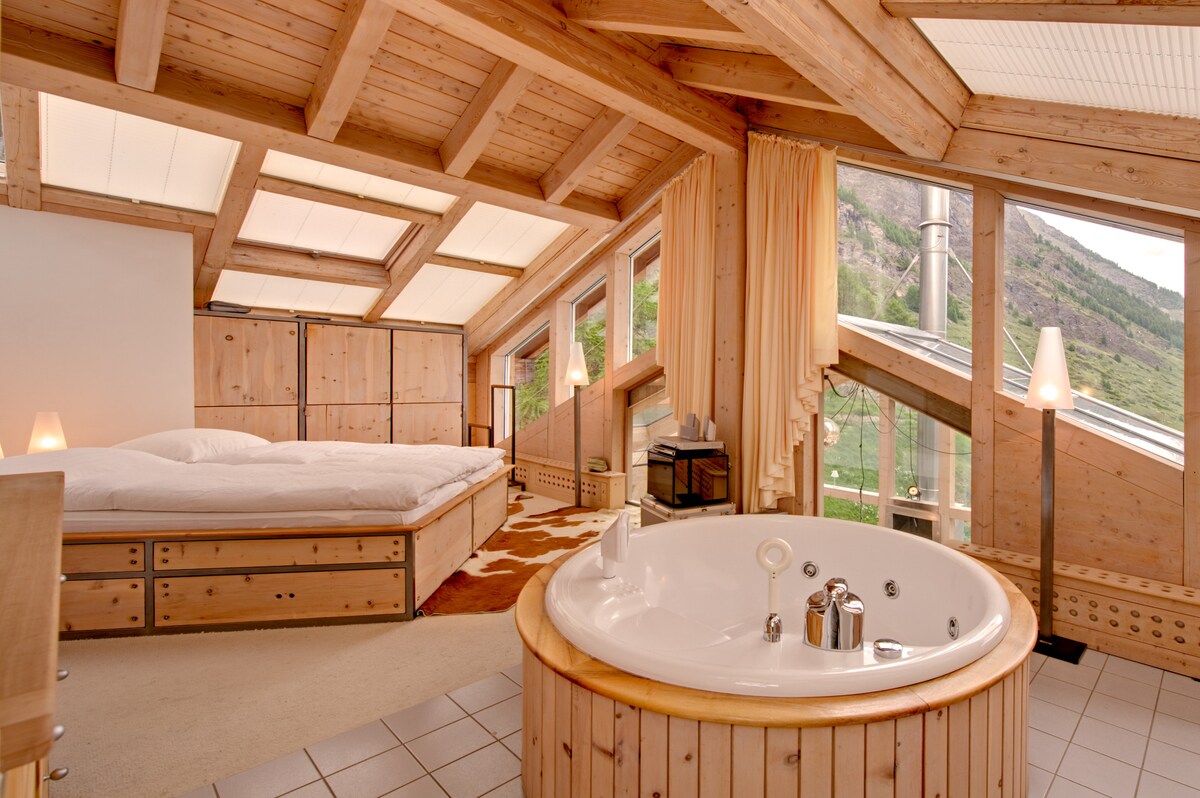 غرفة نوم رئيسية مع حمام جاكوزي دائري مستقل ودش داخلي منفصل/حمام استحمام.