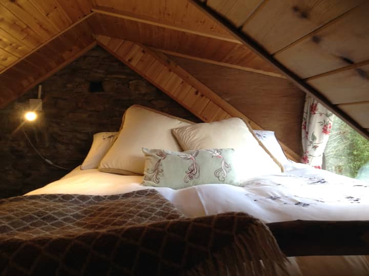 Bed on mezzanine. Curtains block out all light.