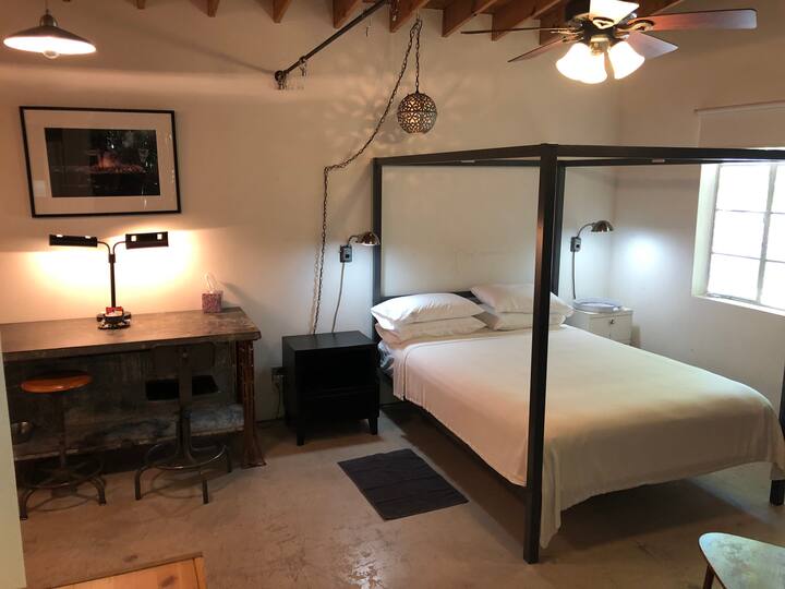 Queen size bed and office/dining area