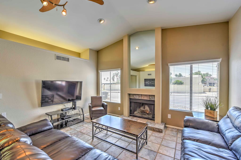 The spacious interior is renovated with a new great room, plush furnishings and large windows that provide views of the backyard.