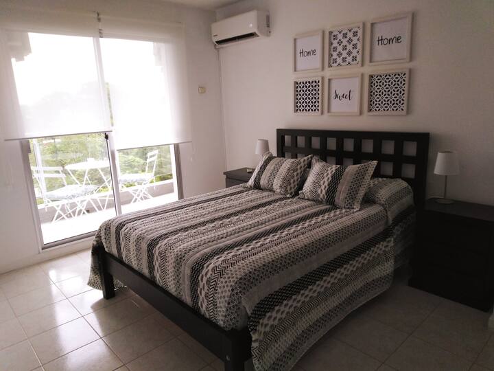 Bedroom en suite. Exit to the balcony with a clear view.