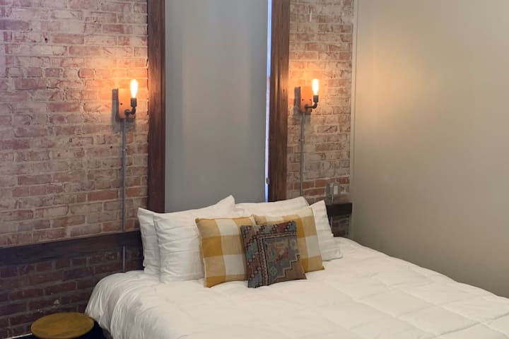 Comfy King Bed with sconce lighting