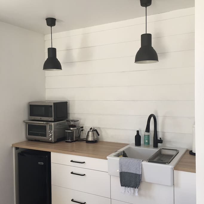 Kitchenette: Breville convection oven, hot plate (pots & pans available), microwave, hot water kettle, french press & pourover by Yield Design Co, and other kitchen essentials.