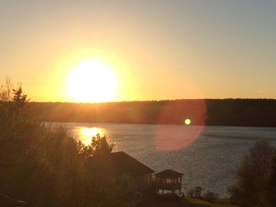 Beautiful sunset off deck which runs the full width of the home.