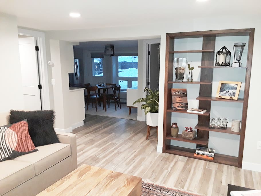 This is the view from the living room. Custom made black walnut shelving system, a view of the kitchen, bedroom to the left and perfect bathroom with the most amazing shower in upper right. Almost 600 square feet of Shangri La.