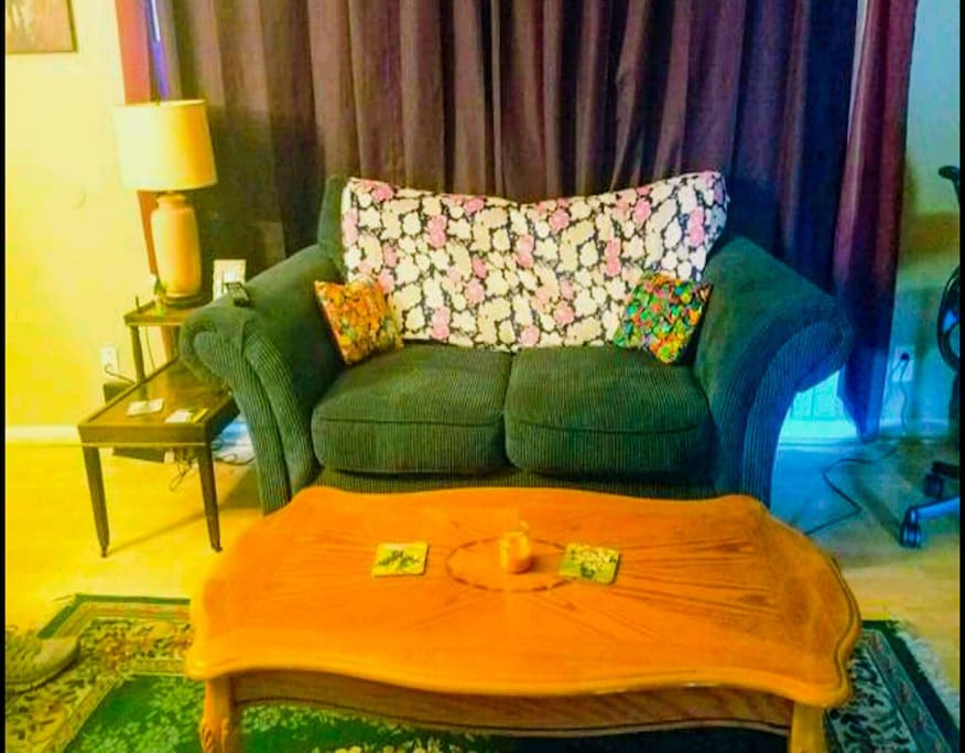 The couch and coffee table in the living room. Get cuddly!