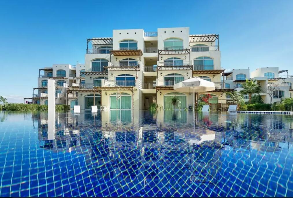 My flat is reflected in this luxurious, adult-sized swimming pool.