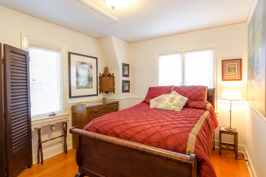 The bedroom is filled with beautiful antiques and original artwork.
