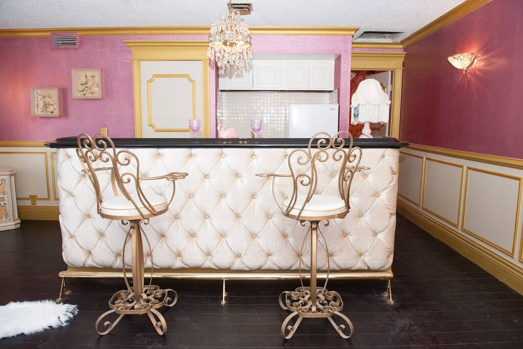 Have a drink on your golden barstool at the solid cherry topped button tuck bar. Ohh!