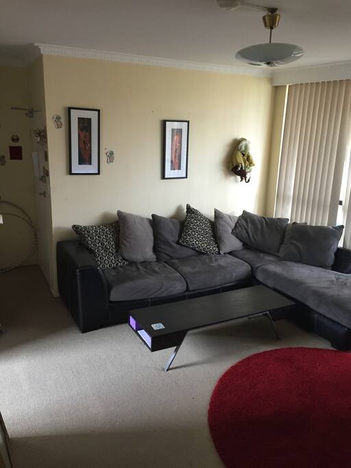 Large couch with a large flat screen tv.