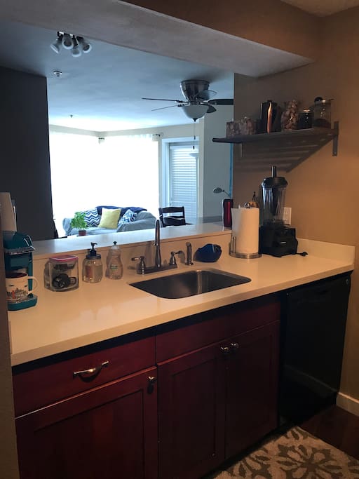 Kitchen, w high bar, is open to living/dining areas