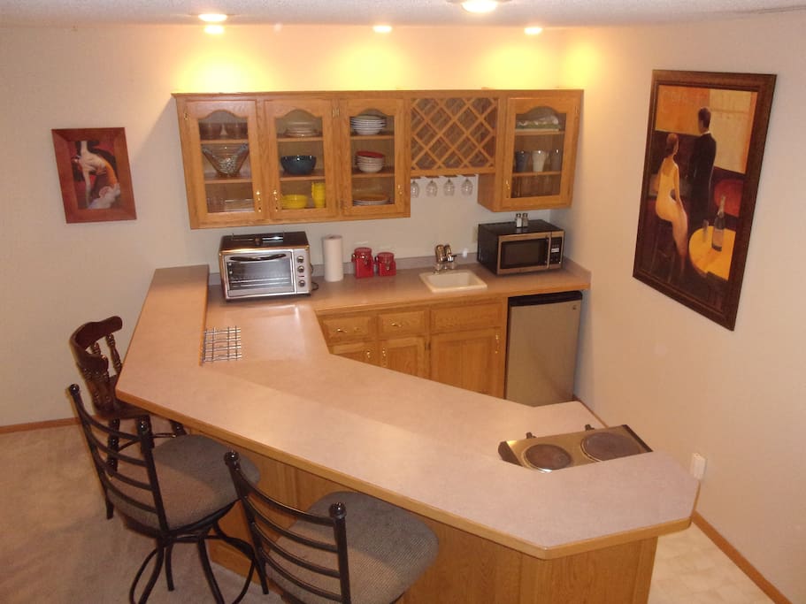 Kitchen w/dual cook top, toaster oven, microwave and small fridge. Stocked w/dishes and cookware. Stand up freezer in garage w/space for you for frozen foods.