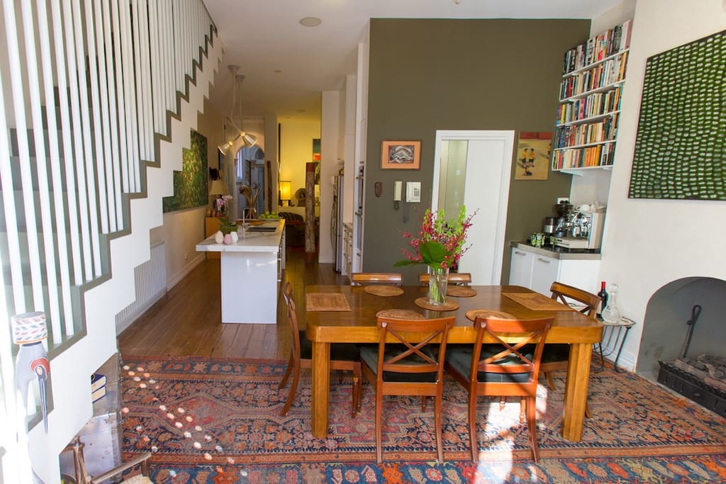 Dining area looking down into kitchen. There is a gas fireplace, hydronic heating, stairs to bedrooms and bathroom. There is a second bathroom and toilet downstairs.