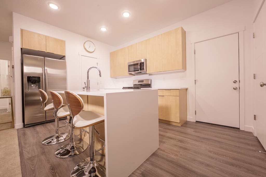 Modern kitchen with minimalist cabinetry and stainless steel appliances.