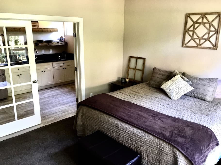 Large hotel style suite w full bedroom and full kitchen separated by french doors, and accompanied by full bath