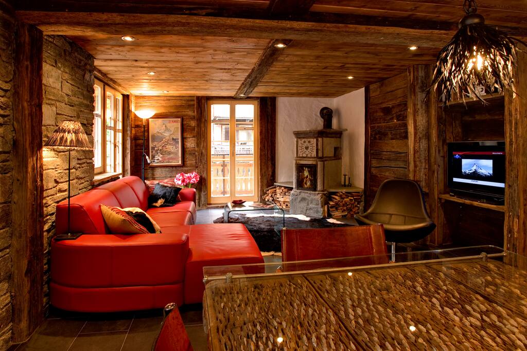 Weathered wood paneling and local granite walls, an antique stone fire-stove