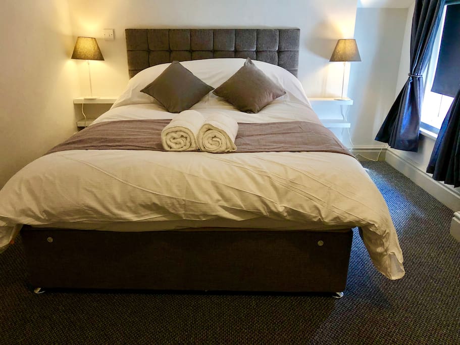 Bedroom with king size bed and blackout blind with in room Safe USB Power Points