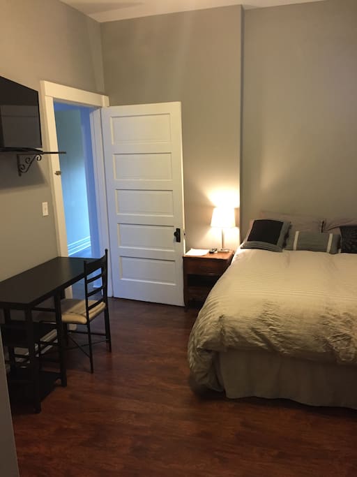 A fully furnished room with a desk for work and 32" television
