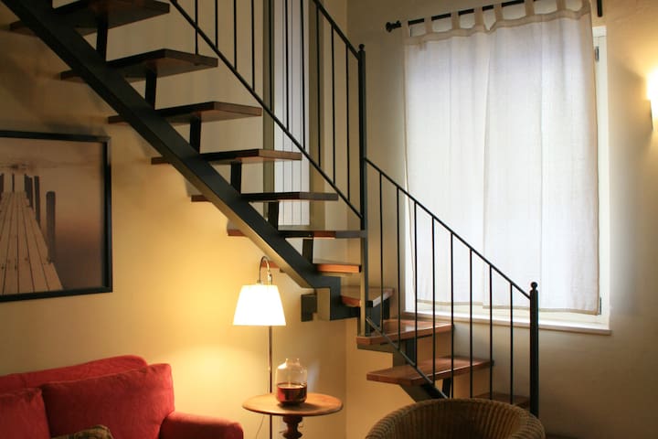 Elegant two-room apartment with loft and exposed beams.