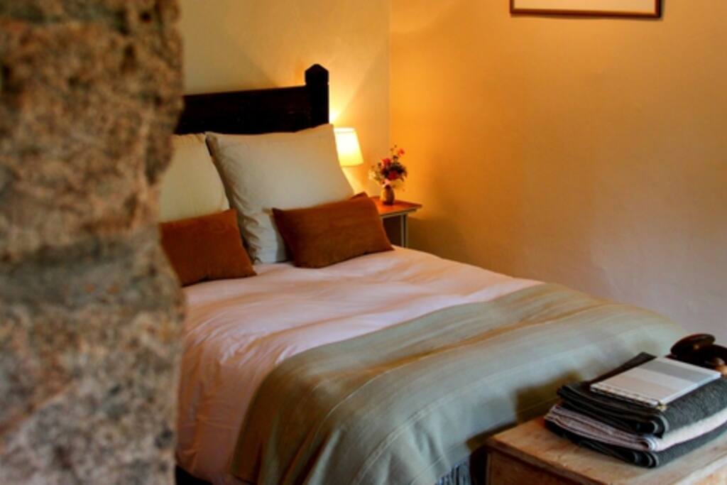 Your cosy bed by the fireplace. A hand-made frame from antique cabinetry.