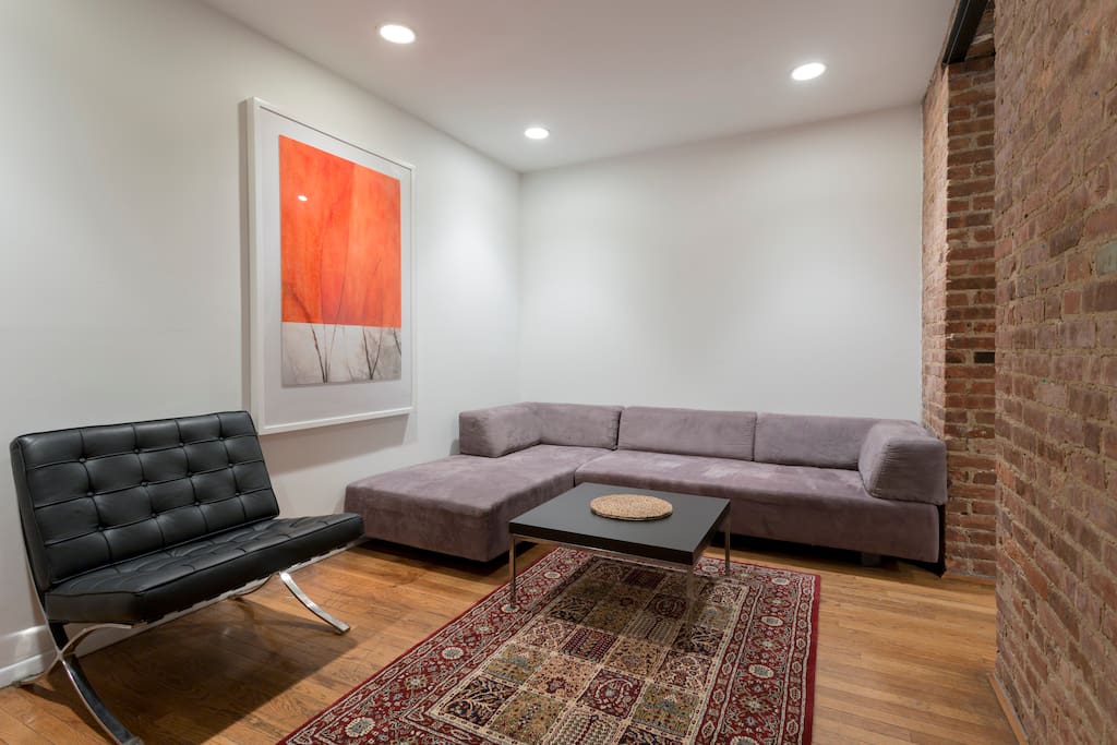 Spacious living room with AC and sectional sleeping sofa.