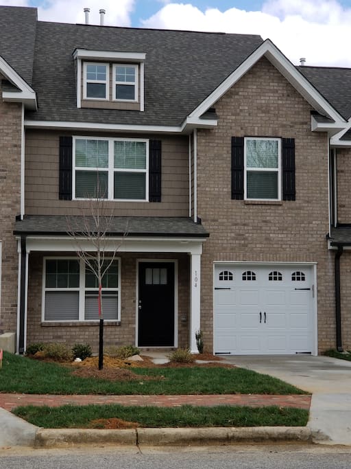 Townhouse with driveway and garage.
