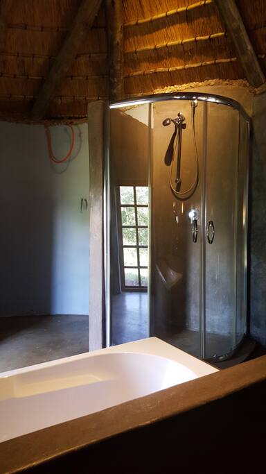 Split level en suite bathroom with bath top and shower.