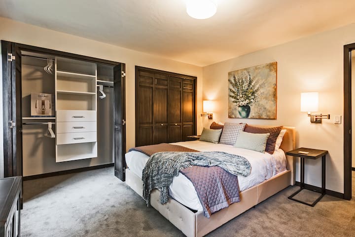 Another comfy queen-sized bed in bedroom #4 with ample closet space and walk-out access.