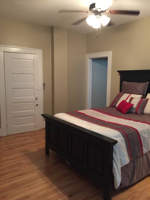 Looking at apt door and into hallway that leads to bathroom and kitchen