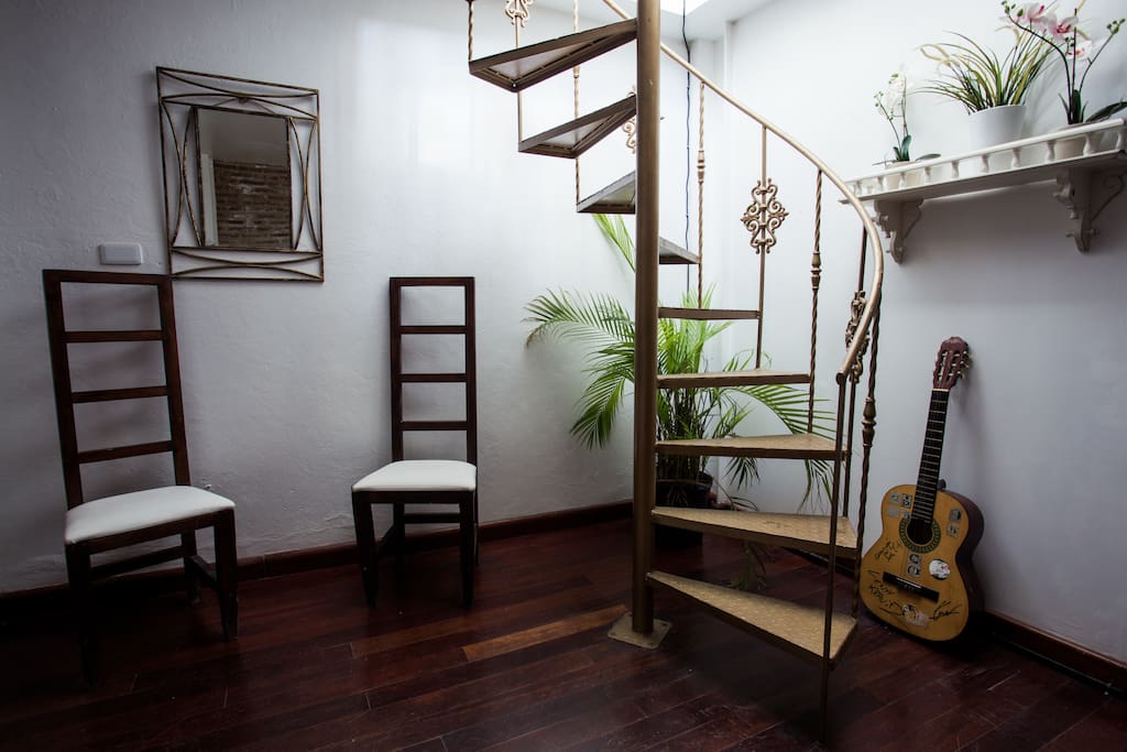 Hallway in front of the room with staircase to the roof