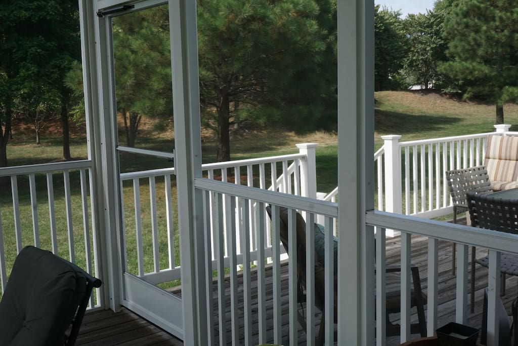 Screen porch opens onto deck and large back yard