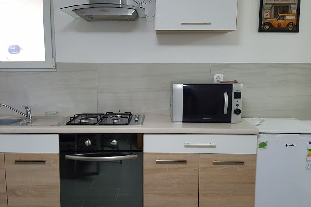 Kitchen with an oven/cooker and microwave