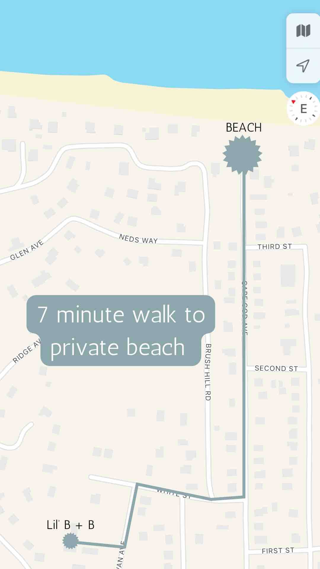 A simplified map displays the surrounding area, indicating a seven-minute walking route to a private beach. Streets and residential paths are labeled, enhancing navigational clarity for guests. The beach is marked with a sun symbol, providing a clear visual reference of its proximity.