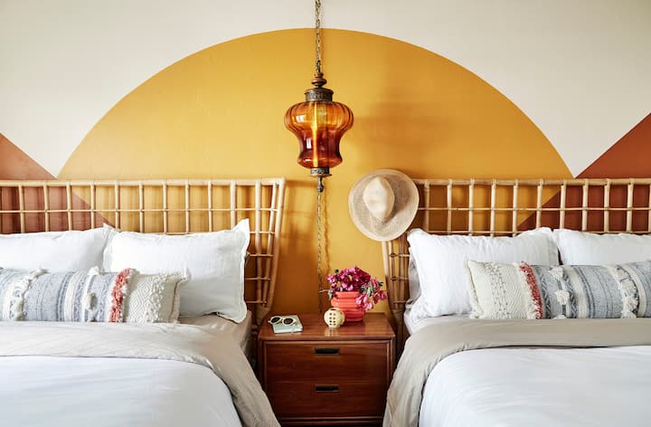 Luxurious bedding accompany two queen beds in the the Sunset bedroom. 